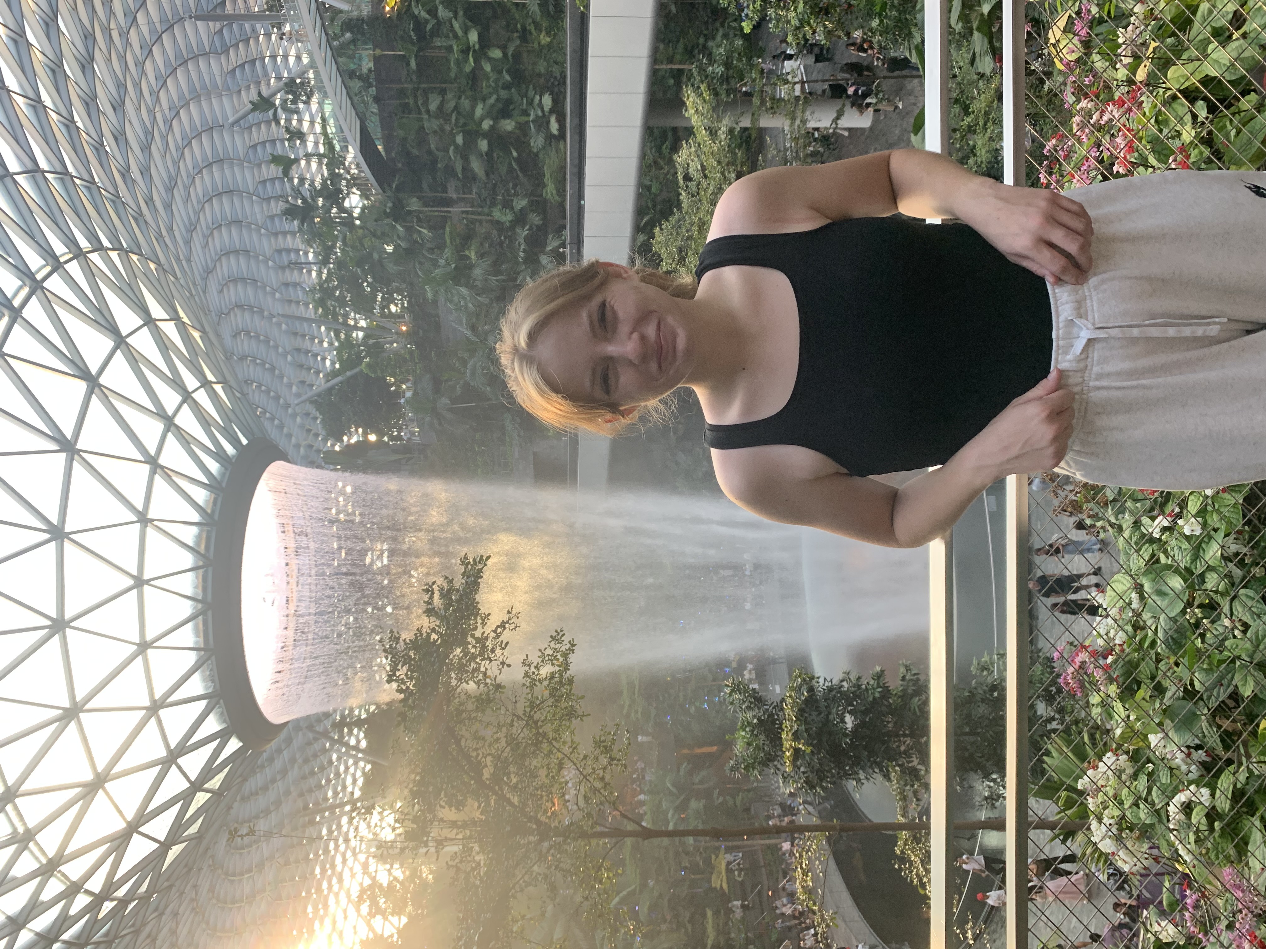 Meredith Clark in front of the indoor waterfall at Jewel Changi Airport, Singapore
